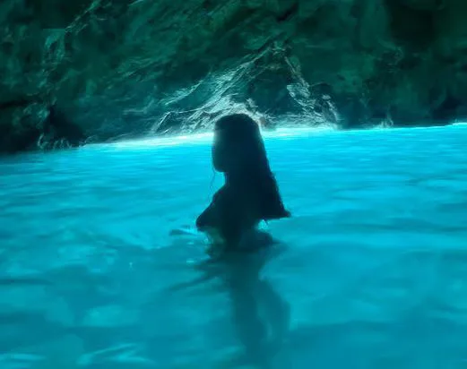 A swimmer inside the Blue Cave
